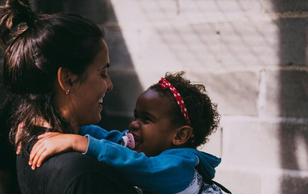 pexels-photo-1170899-1170899 A mother and daughter share a joyful embrace outside, exuding warmth and affection.
