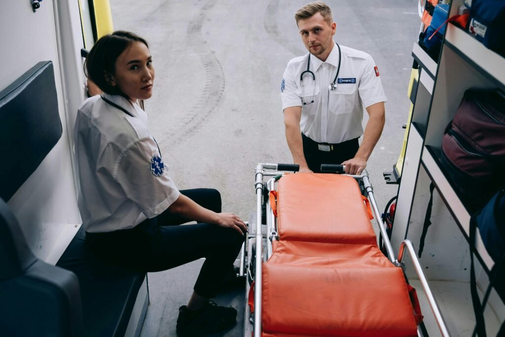 pexels-photo-28123692-28123692 Two paramedics prepare a stretcher inside an ambulance, ready for an emergency response.