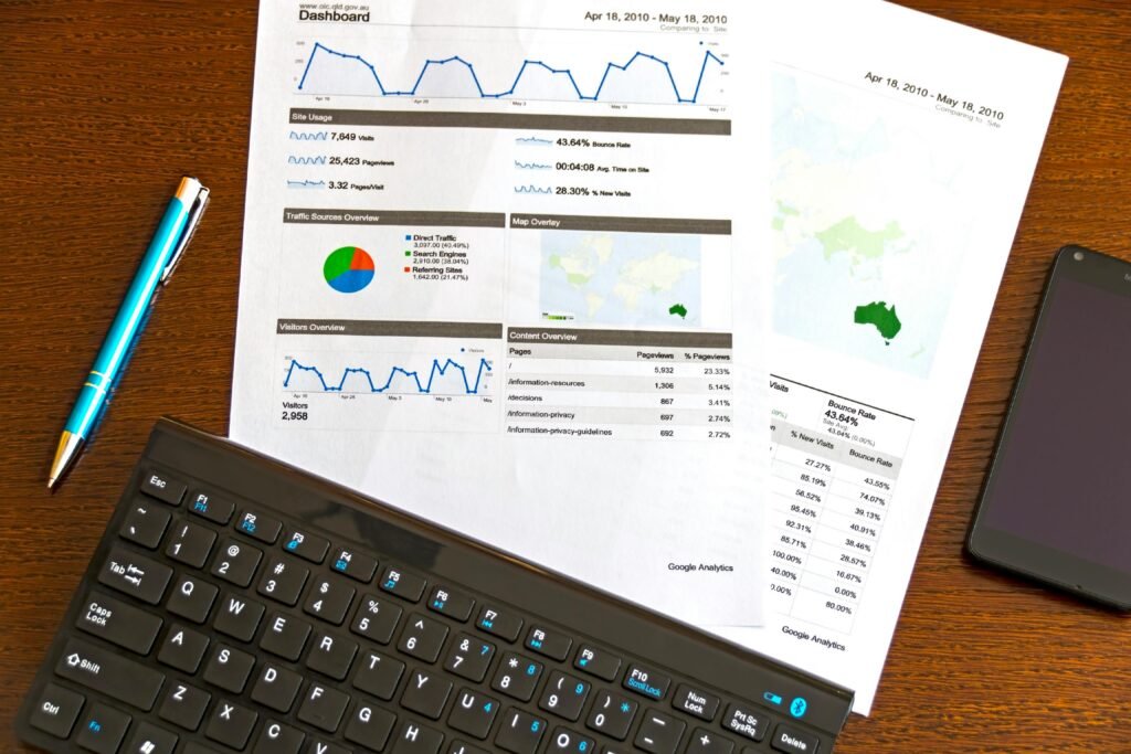 pexels-photo-95916-95916 Flatlay of a business analytics report, keyboard, pen, and smartphone on a wooden desk.